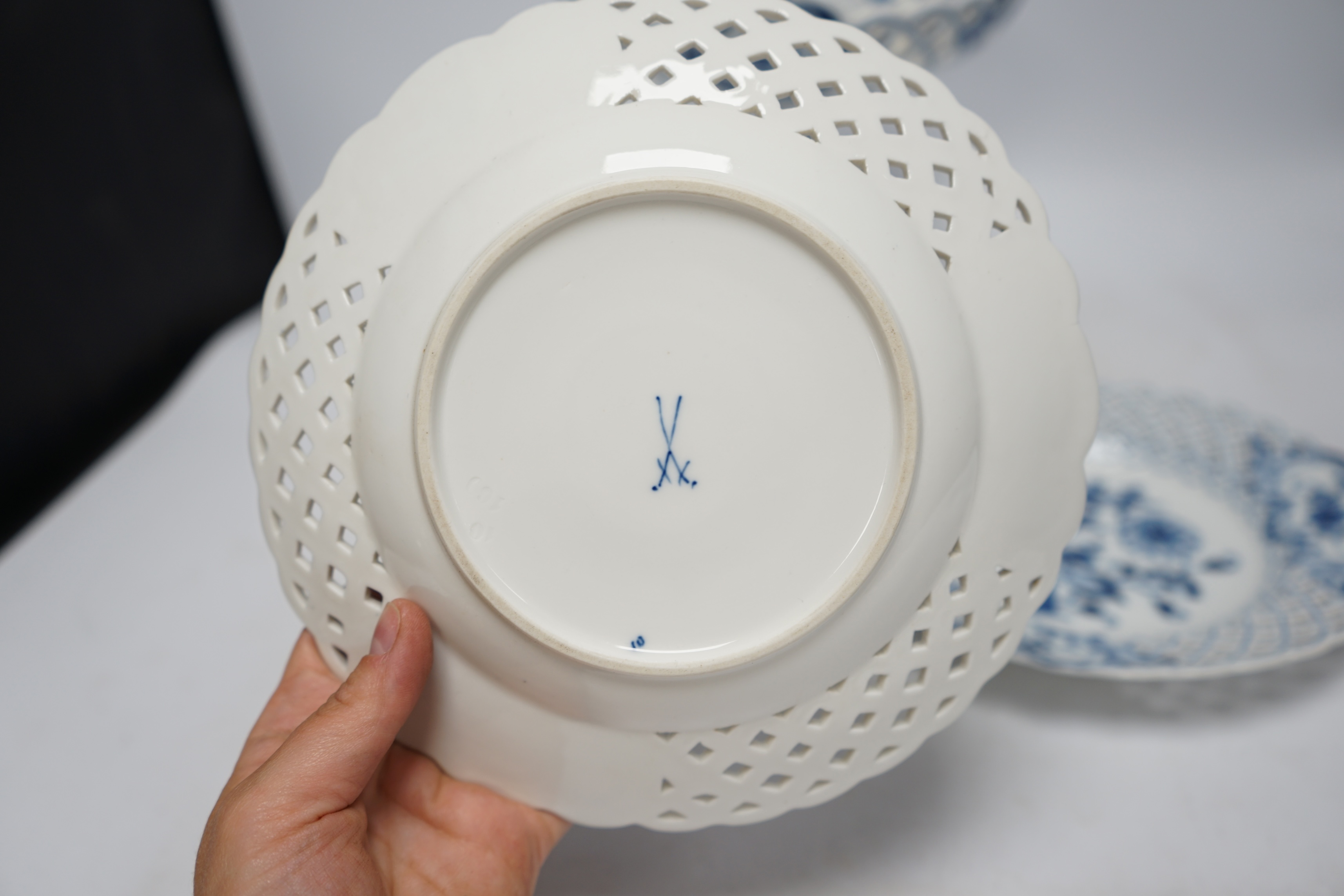 A late 19th Meissen blue and white onion pattern dessert service, consisting of a pair of comports and twelve dishes, all with pierced borders, (14). Condition - poor to good, two plates with pieces of border missing, on